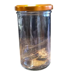 Hög glasburk för 350 g honung med bronsfärgat metallock placerad på träyta.